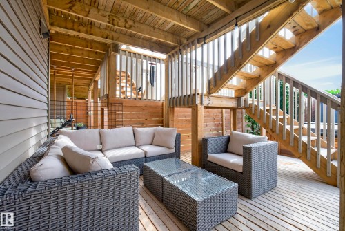 Wood deck featuring a covered outdoor area, wood siding, and multi-level staircase - 45 Joyal Way, St. Albert, AB - Outdoor With Deck Patio Veranda With Exterior