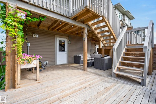 Expansive wood-finish deck with multiple levels and a white exterior door - 45 Joyal Way, St. Albert, AB - Outdoor With Deck Patio Veranda With Exterior