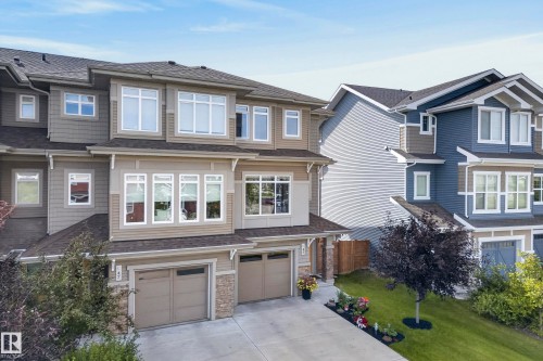 Multi-level exterior with varied siding, prominent windows, attached garage, and stone accents - 45 Joyal Way, St. Albert, AB - Outdoor With Facade