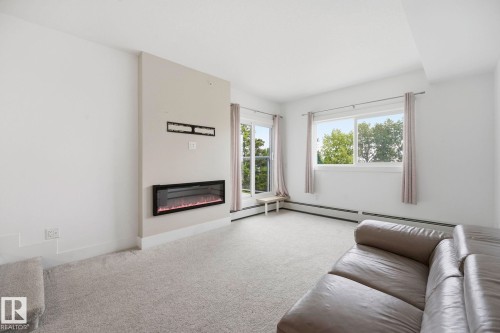 #416 9504 182 St Nw, Edmonton, AB - Indoor Photo Showing Living Room With Fireplace