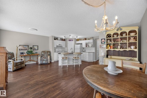 Open-concept living space featuring wood-finish flooring throughout - #7 155 Crocus Cr, Sherwood Park, AB - Indoor