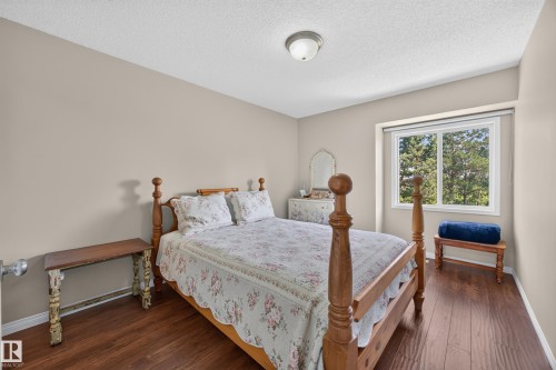 Bedroom featuring wood-finish flooring, neutral wall paint, and a large window - #7 155 Crocus Cr, Sherwood Park, AB - Indoor Photo Showing Bedroom