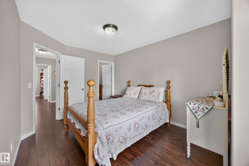 Interior room with wood-finish flooring, light gray wall paint, and white trim - #7 155 Crocus Cr, Sherwood Park, AB - Indoor Photo Showing Bedroom