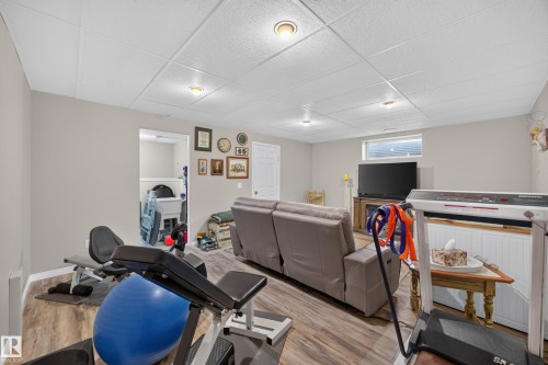 Finished basement space featuring recessed lighting, wood-finish flooring, and light gray walls - #7 155 Crocus Cr, Sherwood Park, AB - Indoor