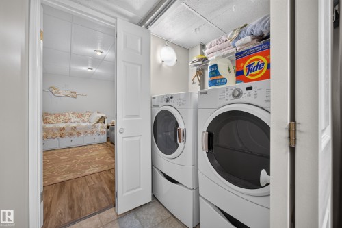 Dedicated laundry area featuring stacked washer and dryer units - #7 155 Crocus Cr, Sherwood Park, AB - Indoor Photo Showing Laundry Room