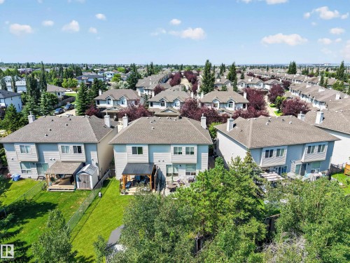 Aerial perspective of a residential neighborhood featuring multiple detached homes with gray siding and shingled roofs - #7 155 Crocus Cr, Sherwood Park, AB - Outdoor