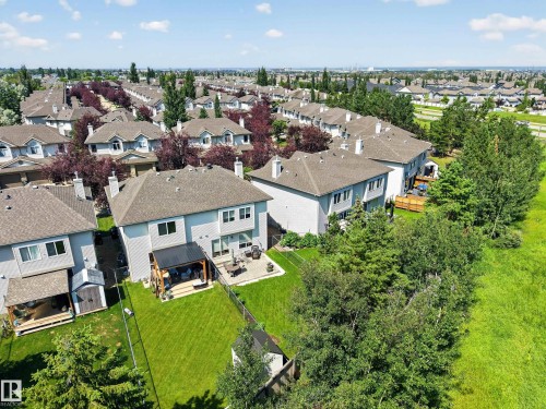 Aerial perspective showcasing a residential community with numerous detached homes featuring pitched roofs and light-colored siding - #7 155 Crocus Cr, Sherwood Park, AB - Outdoor With View