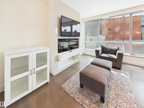 #307 11969 Jasper Av Nw, Edmonton, AB - Indoor Photo Showing Living Room With Fireplace