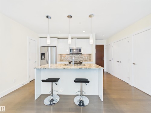 #307 11969 Jasper Av Nw, Edmonton, AB - Indoor Photo Showing Kitchen With Upgraded Kitchen