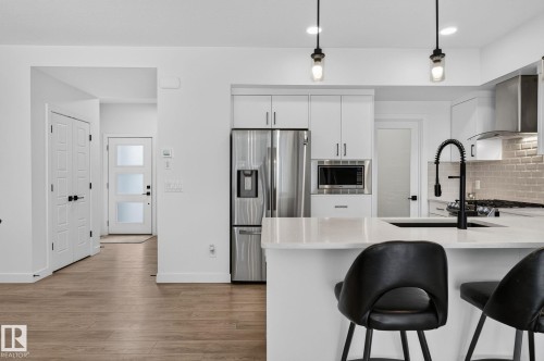 Modern kitchen featuring white cabinetry, stainless steel appliances, and a light-toned countertop - 23027 96 Avenue Nw, Edmonton, AB - Indoor Photo Showing Kitchen With Stainless Steel Kitchen With Upgraded Kitchen