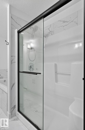 Shower enclosure with black-framed sliding glass door - 23027 96 Avenue Nw, Edmonton, AB - Indoor Photo Showing Bathroom