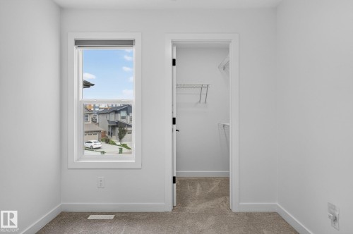 Light-filled room featuring a single window, neutral wall paint, and plush carpet flooring - 23027 96 Avenue Nw, Edmonton, AB - Indoor Photo Showing Other Room