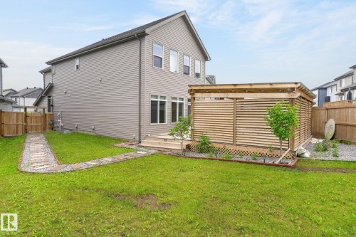 Expansive backyard featuring a stone pathway, a wooden privacy structure, a multi-level deck, and a wooden perimeter fence - 23027 96 Avenue Nw, Edmonton, AB - Outdoor With Exterior