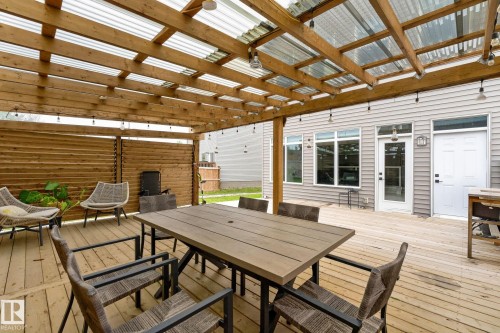Expansive wood deck with a clear-panel roof structure - 23027 96 Avenue Nw, Edmonton, AB - Outdoor With Deck Patio Veranda With Exterior