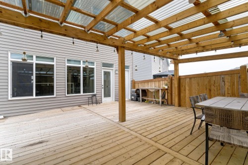 Expansive wooden deck featuring a full-length pergola with a translucent roof and integrated string lighting - 23027 96 Avenue Nw, Edmonton, AB - Outdoor With Deck Patio Veranda With Exterior