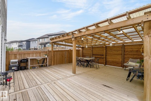 Expansive wooden deck featuring a covered pergola with a transparent roof and exposed beams - 23027 96 Avenue Nw, Edmonton, AB - Outdoor With Deck Patio Veranda With Exterior