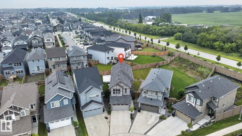 Modern suburban setting featuring a residential street, contemporary architecture, and individual driveways - 23027 96 Avenue Nw, Edmonton, AB - Outdoor With View