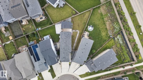 Aerial perspective showcasing a residential cul-de-sac with varied rooflines and a mix of paved driveways and green spaces - 23027 96 Avenue Nw, Edmonton, AB - 