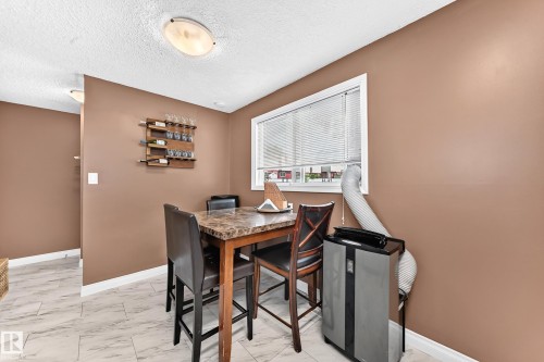 Recessed lighting, wood-finish wall decor, window with blinds, and tile flooring - 64 Habitat Crescent Nw, Edmonton, AB - Indoor Photo Showing Dining Room