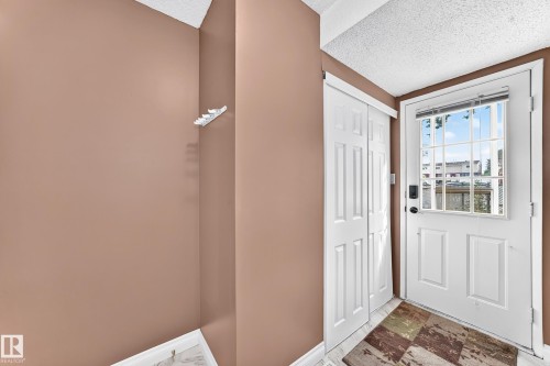 White entry door with a divided light window - 64 Habitat Crescent Nw, Edmonton, AB - Indoor Photo Showing Other Room