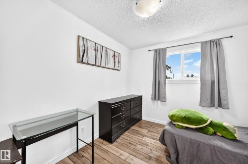 Recessed window with gray drapes, wood-finish flooring, and a flush mount ceiling light - 64 Habitat Crescent Nw, Edmonton, AB - Indoor