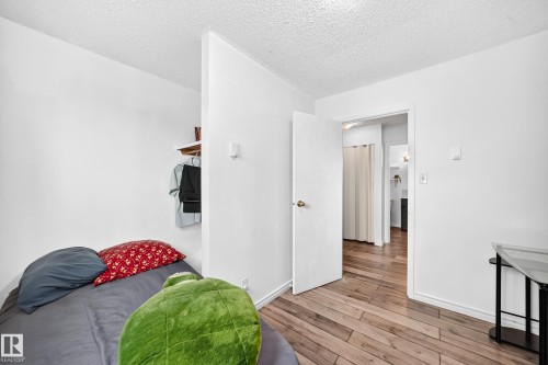 Hardwood-finish flooring, white painted walls, and built-in shelving - 64 Habitat Crescent Nw, Edmonton, AB - Indoor Photo Showing Other Room