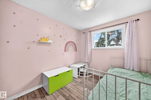 Hardwood-style flooring, white window trim, and a flush mount ceiling light - 64 Habitat Crescent Nw, Edmonton, AB - Indoor