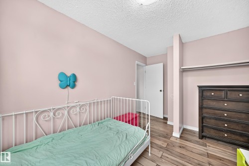 Wood-finish flooring throughout - 64 Habitat Crescent Nw, Edmonton, AB - Indoor Photo Showing Bedroom