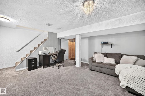 Carpeted flooring throughout, recessed lighting, and a decorative ceiling fixture - 64 Habitat Crescent Nw, Edmonton, AB - Indoor
