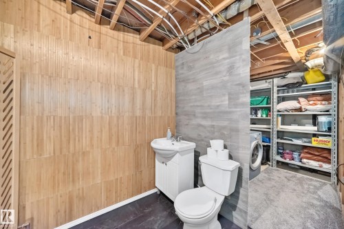 Wood-finish wall paneling with a louvered partition - 64 Habitat Crescent Nw, Edmonton, AB - Indoor Photo Showing Bathroom