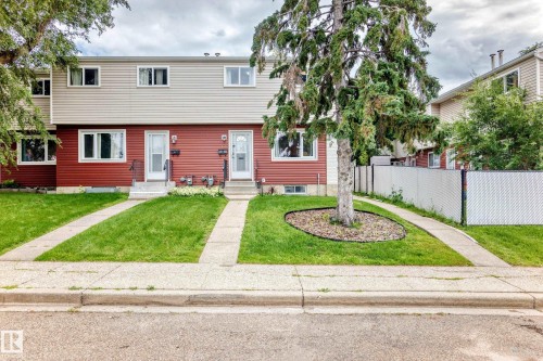Two-story townhouse with red siding and light-colored upper-level siding - 64 Habitat Crescent Nw, Edmonton, AB - Outdoor