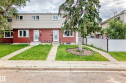Two-story townhouse with red siding and light-colored upper-level siding - 