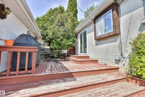 Wood deck with a built-in railing, offering direct access to the interior via a sliding glass door - 3824 111B Street Nw, Edmonton, AB - Outdoor With Deck Patio Veranda With Exterior