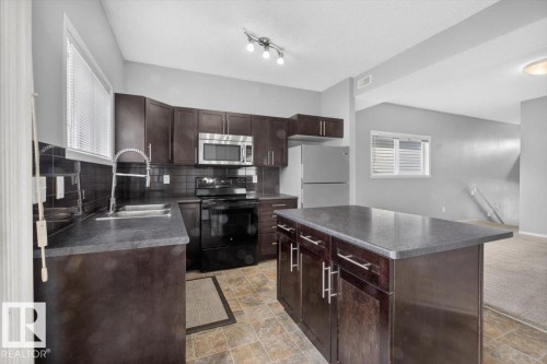 #25 6520 2 Av Sw, Edmonton, AB - Indoor Photo Showing Kitchen With Double Sink