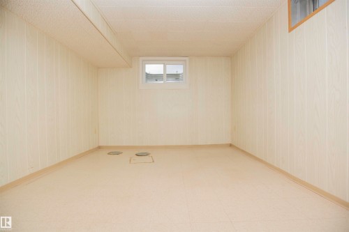 White wood-panel walls with a drop ceiling - 9107 58 Street Nw, Edmonton, AB - Indoor Photo Showing Other Room