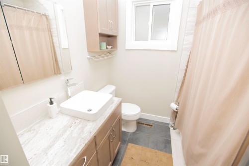 White rectangular vessel sink with a chrome faucet, set on a light-toned countertop - 9107 58 Street Nw, Edmonton, AB - Indoor Photo Showing Bathroom
