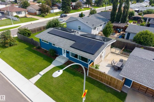 Exterior with solar panels, blue siding, a paved patio, and a fenced yard - 9107 58 Street Nw, Edmonton, AB - Outdoor
