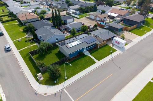 Corner lot residence featuring a blue exterior, solar panels, and a fenced backyard - 9107 58 Street Nw, Edmonton, AB - Outdoor With View