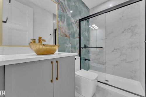 Modern vanity with a gold vessel sink and faucet, quartz countertop, and gray cabinetry - 2039 156 Avenue Nw, Edmonton, AB - Indoor Photo Showing Bathroom