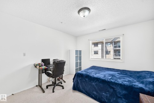 Wall-to-wall carpeting and white walls - #324 279 Suder Greens Dr Nw, Edmonton, AB - Indoor Photo Showing Bedroom