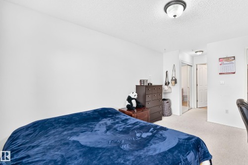 Wall-to-wall carpeting, overhead lighting, and white walls - #324 279 Suder Greens Dr Nw, Edmonton, AB - Indoor Photo Showing Bedroom