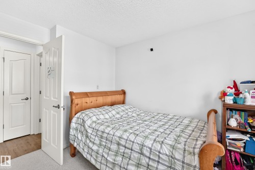 Wood-finish flooring - #324 279 Suder Greens Dr Nw, Edmonton, AB - Indoor Photo Showing Bedroom