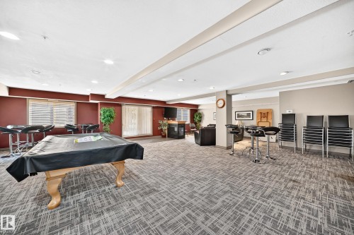 Expansive room with patterned carpeting, recessed lighting, and a pool table - #324 279 Suder Greens Dr Nw, Edmonton, AB - Indoor Photo Showing Other Room