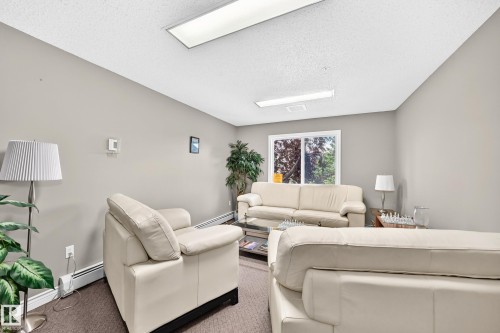 Bright, naturally lit living space featuring recessed ceiling fixtures and large windows with garden views - #324 279 Suder Greens Dr Nw, Edmonton, AB - Indoor Photo Showing Other Room