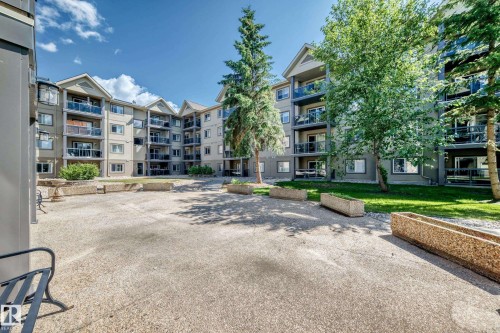Multi-story building exterior with individual balconies featuring glass railings - #324 279 Suder Greens Dr Nw, Edmonton, AB - Outdoor With Balcony With Facade
