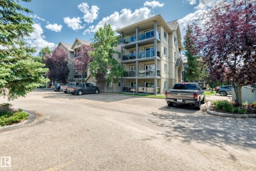 Multi-story building with balconies featuring glass railings - #324 279 Suder Greens Dr Nw, Edmonton, AB - Outdoor With Balcony With Facade