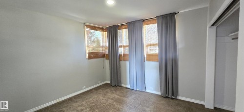 Recessed lighting and multiple windows with woven wood blinds - 4317 50 Street, Vegreville, AB - Indoor Photo Showing Other Room