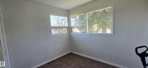 Light grey wall paint with a textured carpet floor - 4317 50 Street, Vegreville, AB - Indoor Photo Showing Other Room
