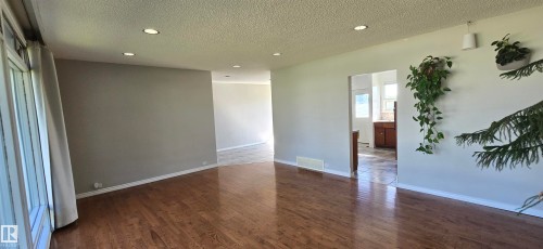 Wood-finish flooring throughout, recessed lighting, and bright white walls - 4317 50 Street, Vegreville, AB - Indoor Photo Showing Other Room