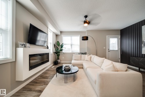 #1 2803 James Mowatt Tr Sw, Edmonton, AB - Indoor Photo Showing Living Room With Fireplace